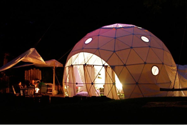 Glamping dome at night at the Dome Garden