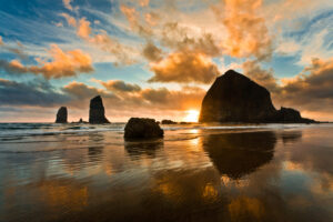 The wild Oregon coastline invites many vacationers, Haystack Rock is one of its spectacles